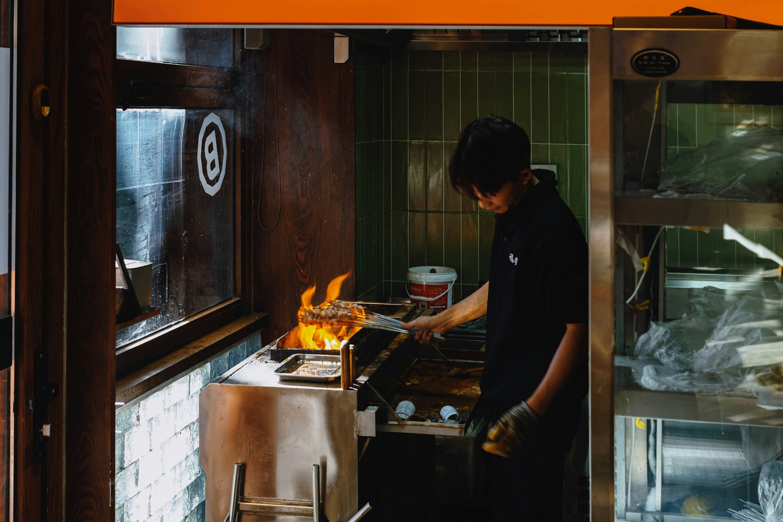 Open kitchen at Fig & Ember with cooks working over live fire