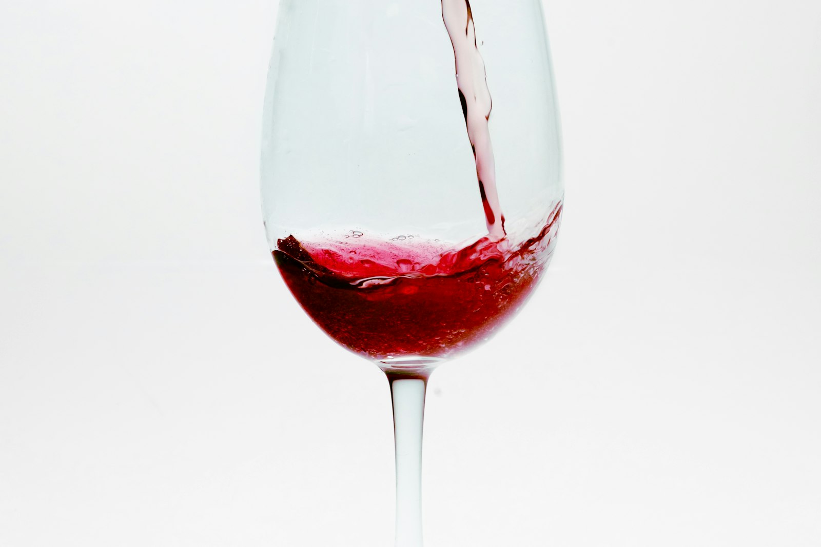 A glass of natural wine on a wood table