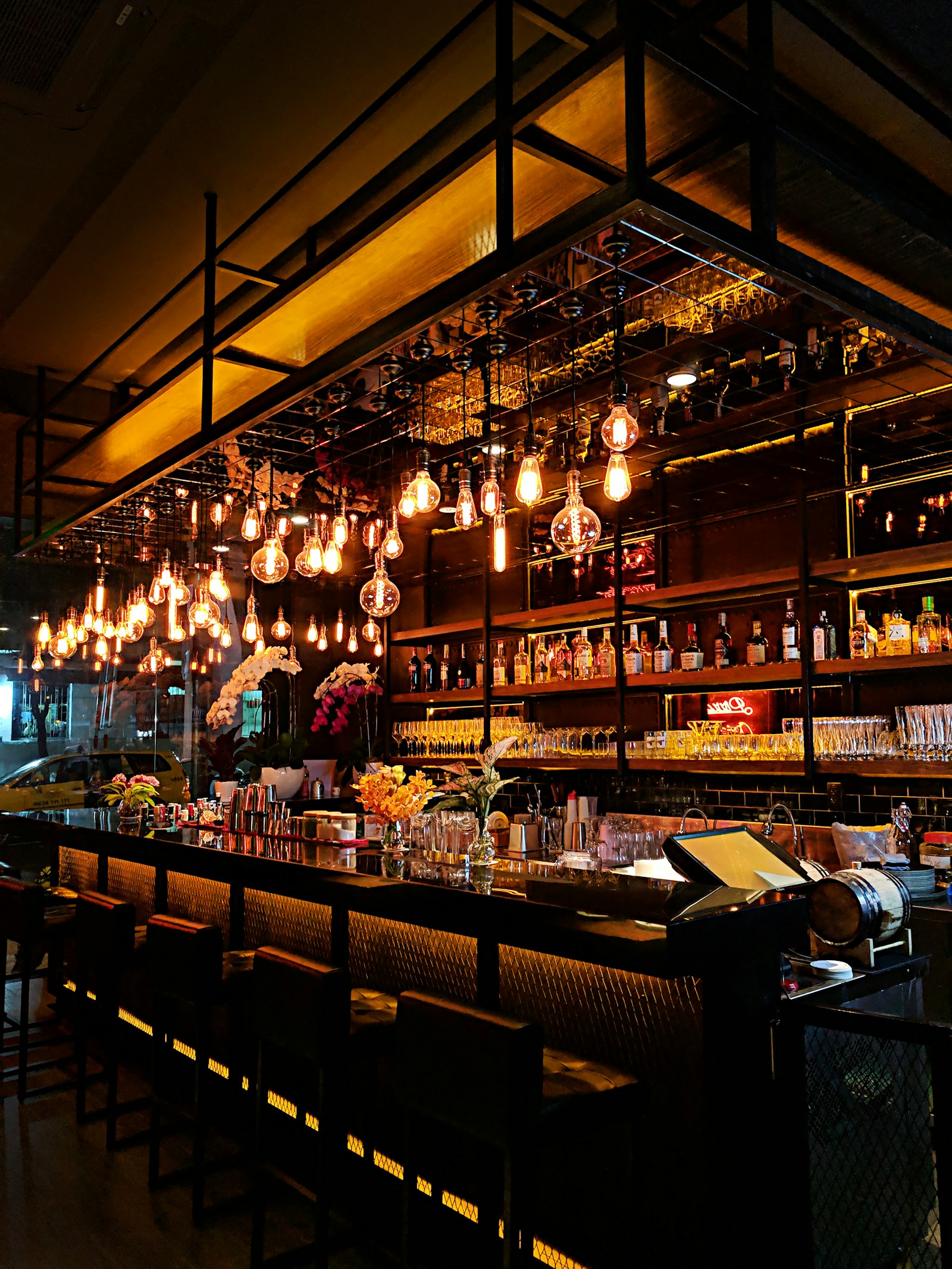 Warm string lighting over the bar at Fig & Ember