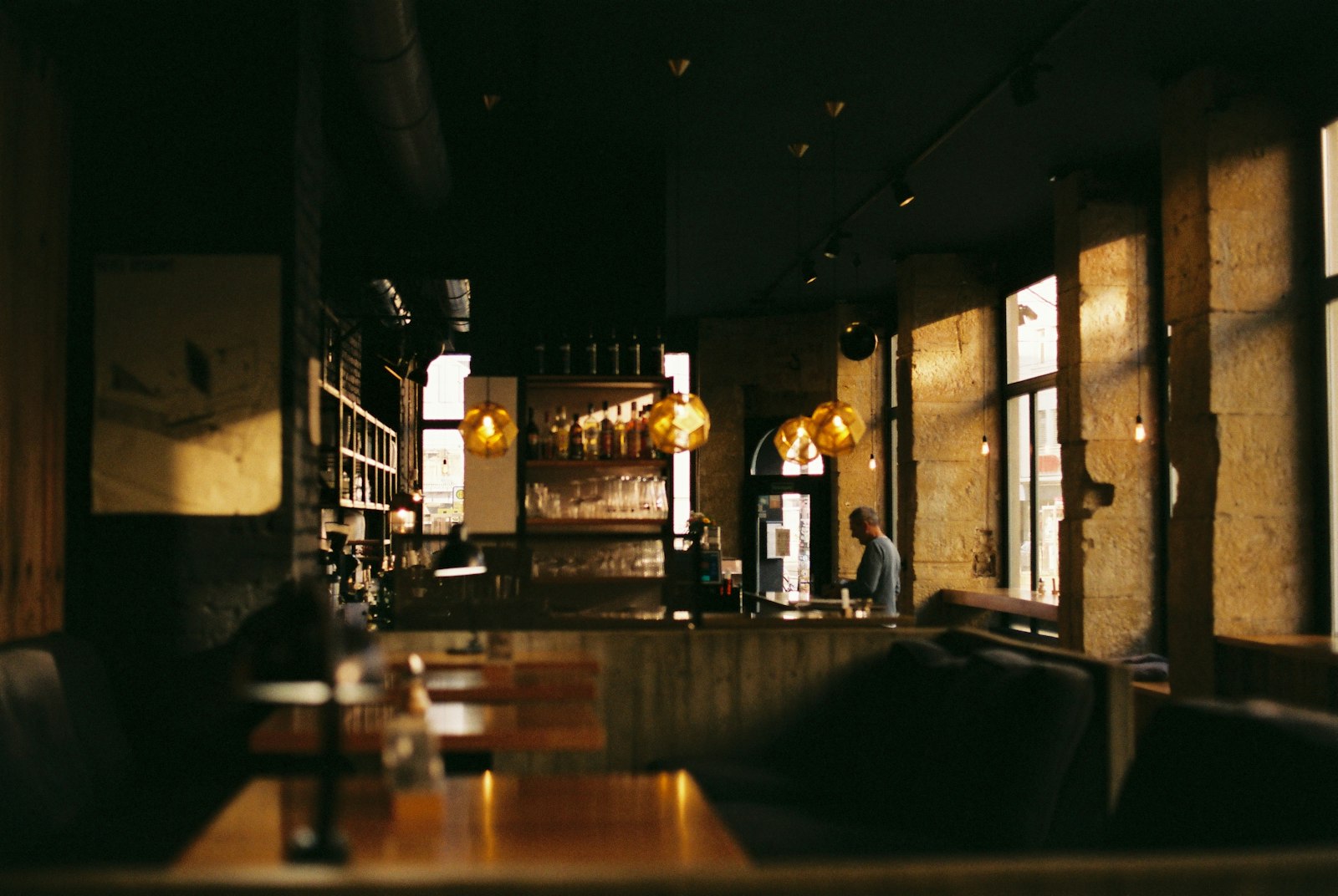 Dimly lit restaurant with tables and chairs set