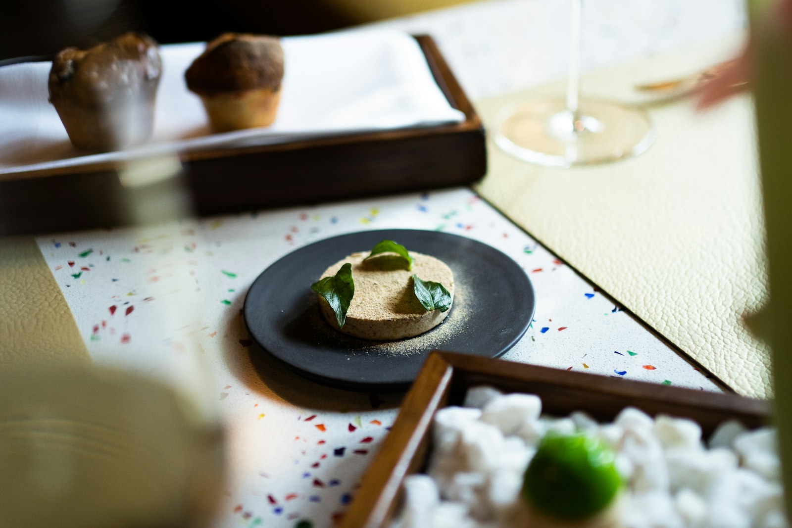 A plate of food beside a glass of wine on the table